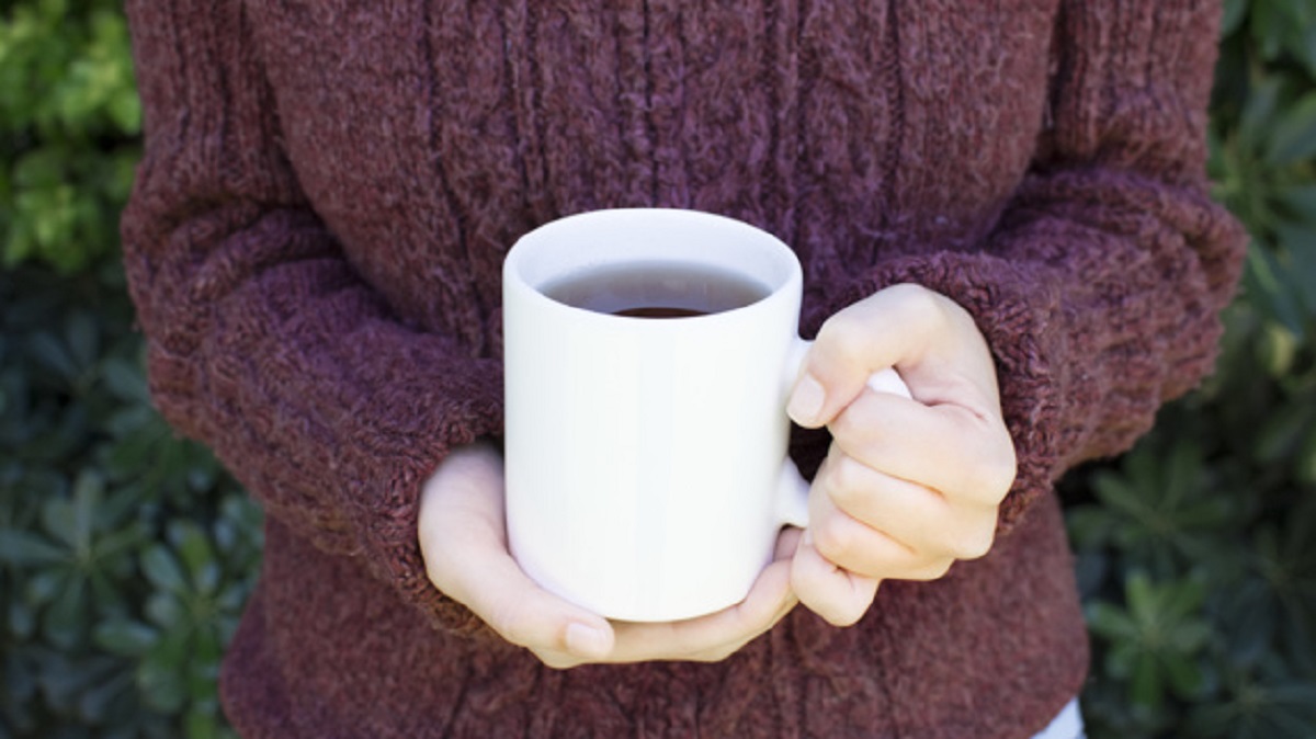 close-up-woman-wearing-woolen-sweater-holding-mug-herbal-tea_23-2148092083